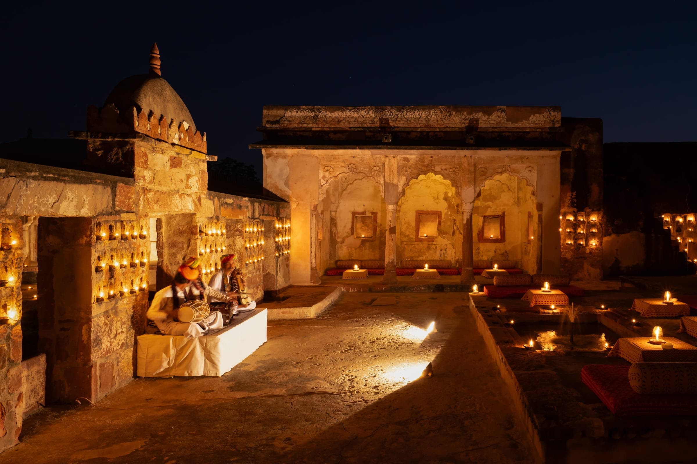 Musicians performing by candlelight in the fort